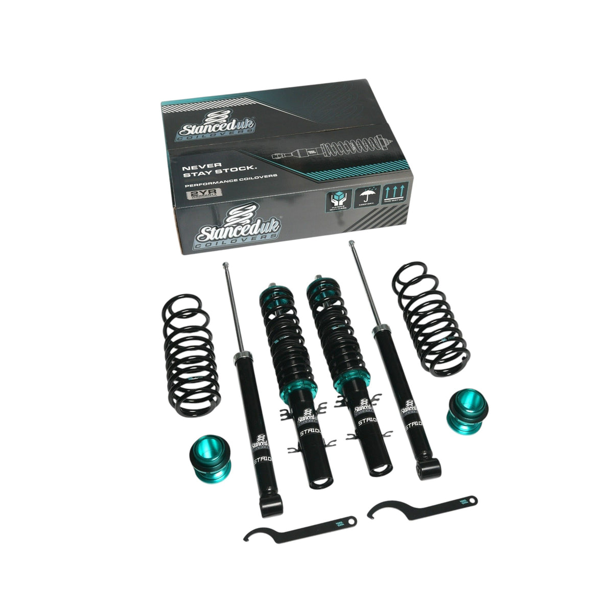 Stanced UK STA104 coilover kit showing front and rear shocks, lowering springs, adjusters, and C-spanners with retail box
