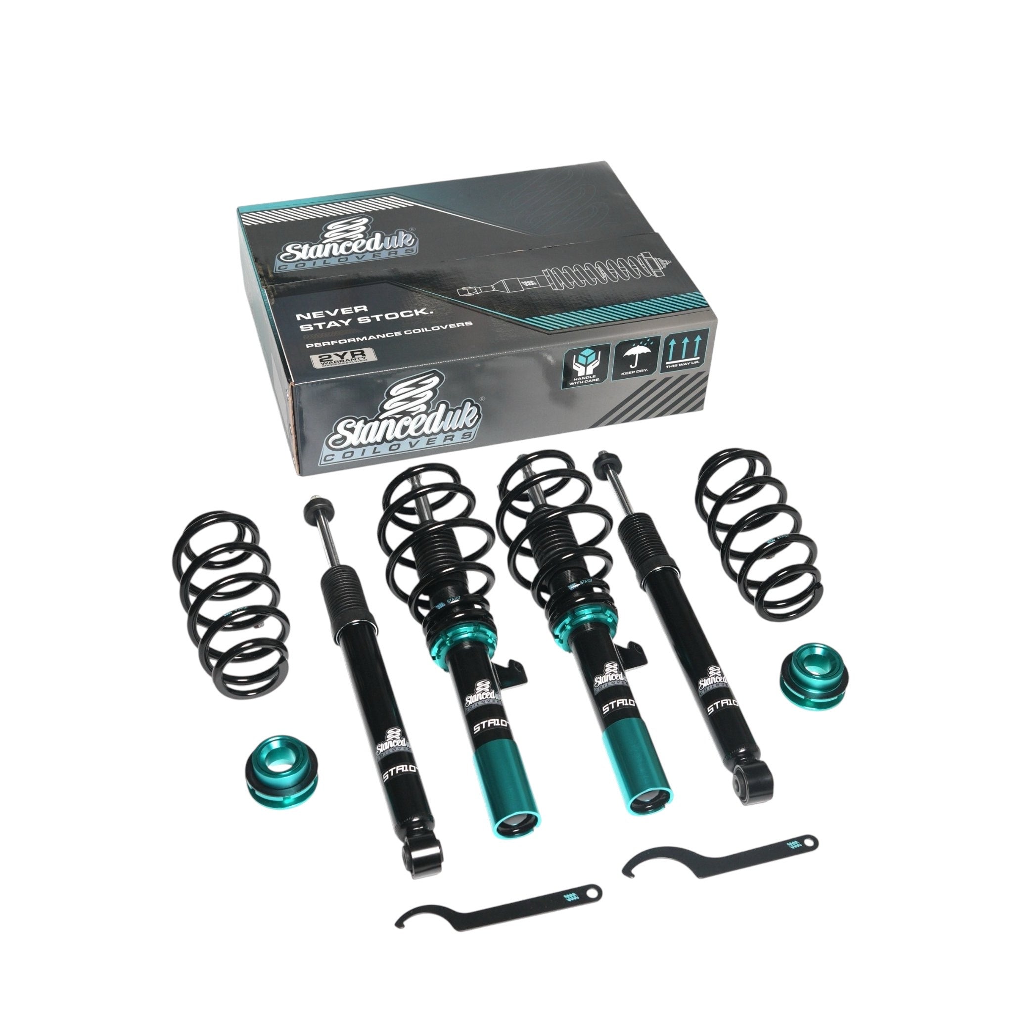 Full Stanced UK STA106 coilover kit with retail box, showing front and rear dampers, springs, and adjusters


