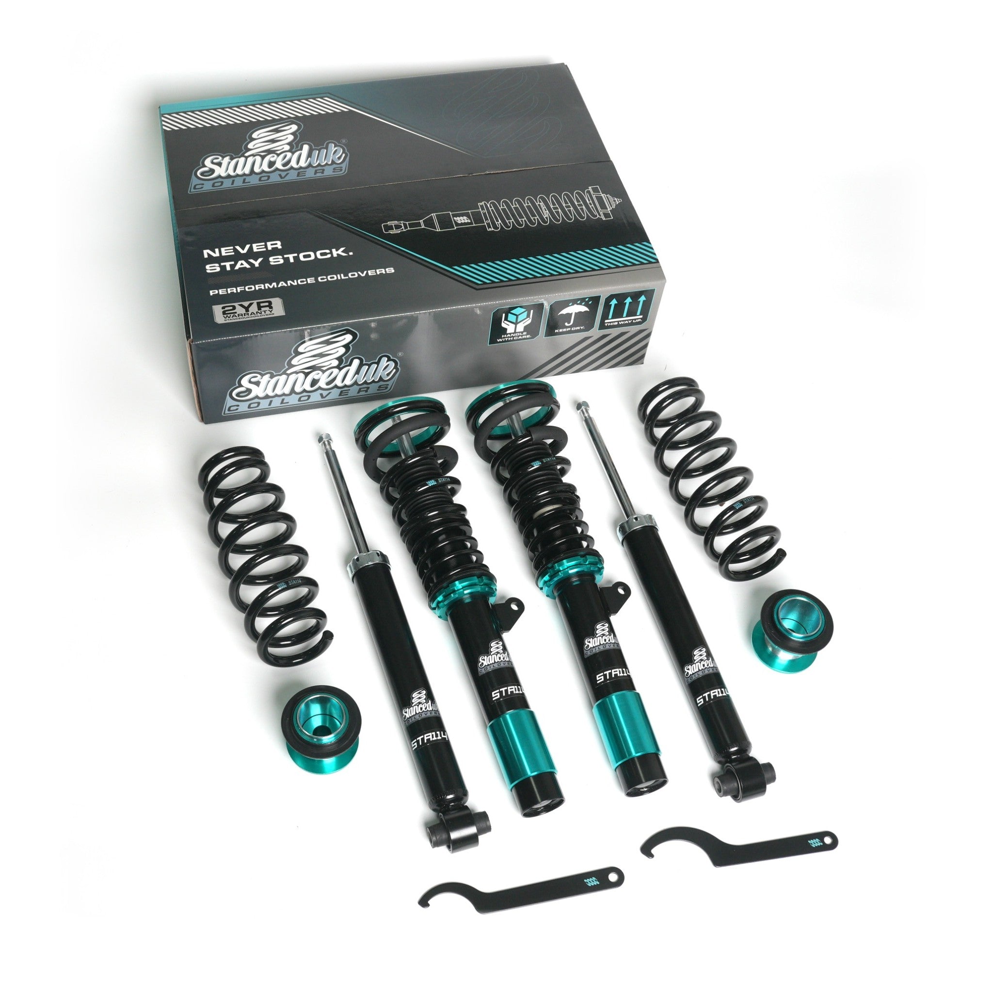 Full Stanced UK® STA114 coilover suspension kit with branded box, springs, shocks, and tools laid out on white background.