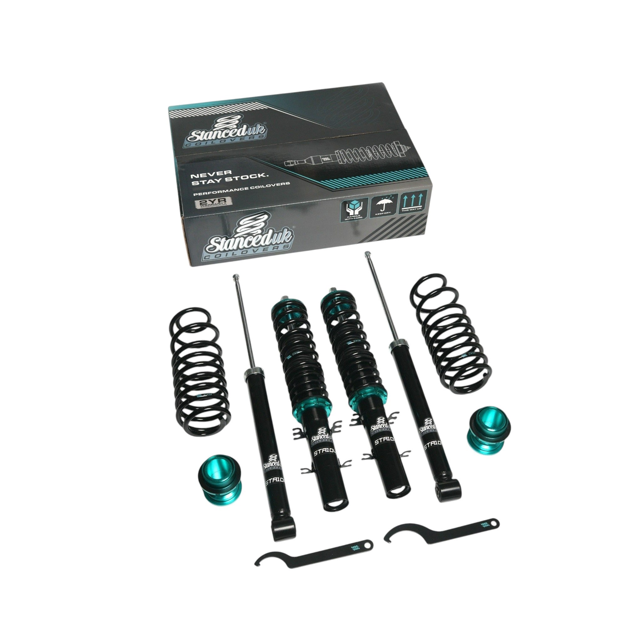 Stanced UK STA104 coilover kit showing front and rear shocks, lowering springs, adjusters, and C-spanners with retail box